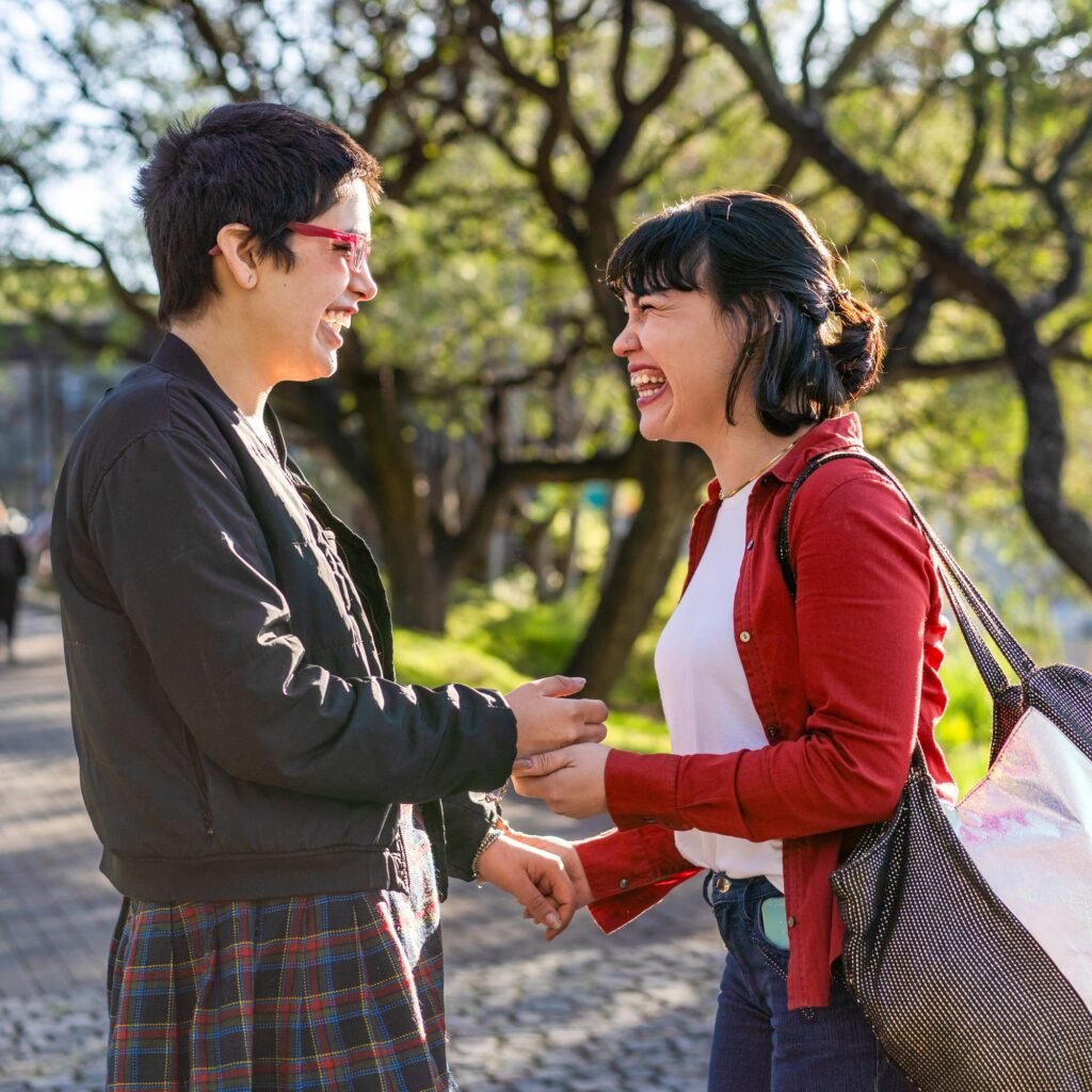 Empowered LGBT couple of women exchanging a conspiratorial laugh as they gaze into each other's eyes